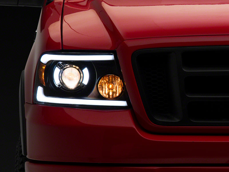 Raxiom 04-08 Ford F-150 Axial Series Projector Headlights with LED Bar- Black Housing- Clear Lens