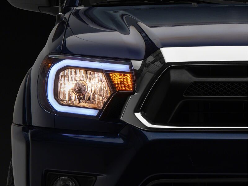 Raxiom 12-15 Toyota Tacoma Axial Series Headlights/Seq LED Bar- Black- Clear Lens