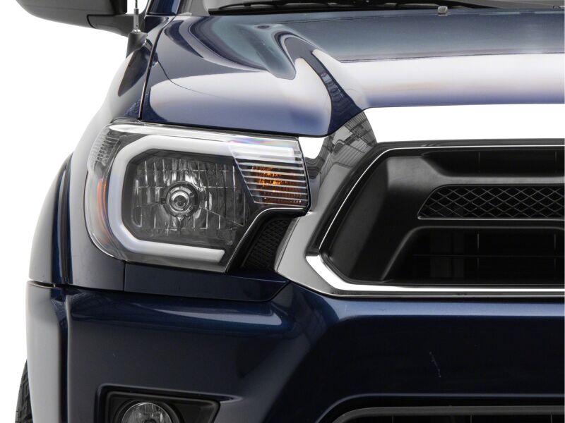 Raxiom 12-15 Toyota Tacoma Axial Series Headlights/Seq LED Bar- Black- Clear Lens