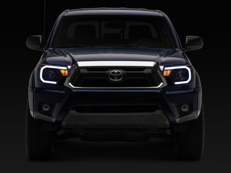 Raxiom 12-15 Toyota Tacoma Axial Series Headlights/Seq LED Bar- Black- Clear Lens